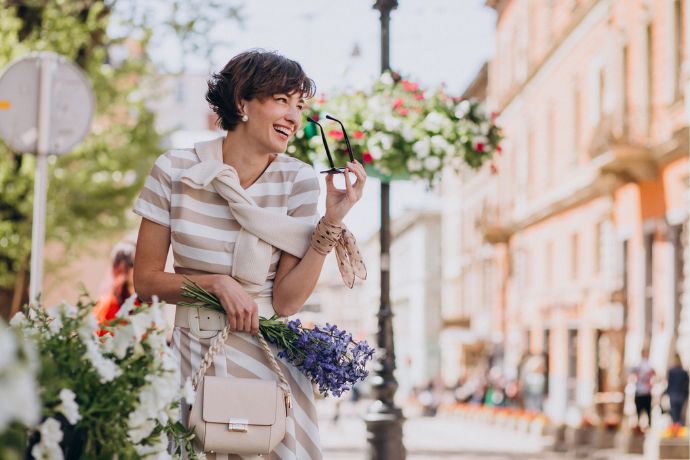 Young woman with flowers walking in Rome, Italy.