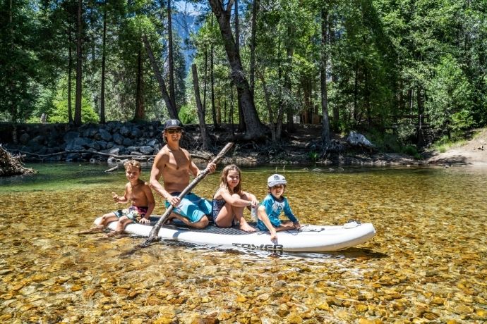 A family is riding on a boat during the daytime
