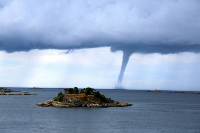 A large tornado is coming out of the sky