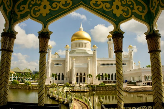 a large white building with a gold dome in Brunei
