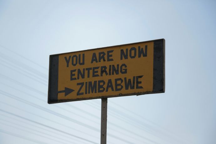 A street sign that says you are now entering Zimbabwe