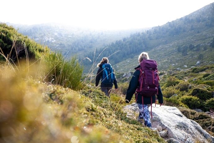A woman walking in the Rocky Mountains during the day
