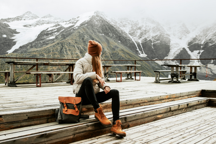 Solo traveler enjoying snowy mountains as one of the best things to do