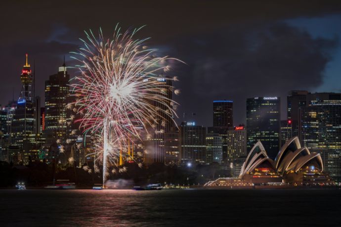 Fireworks display over Sydney buildings at nighttime