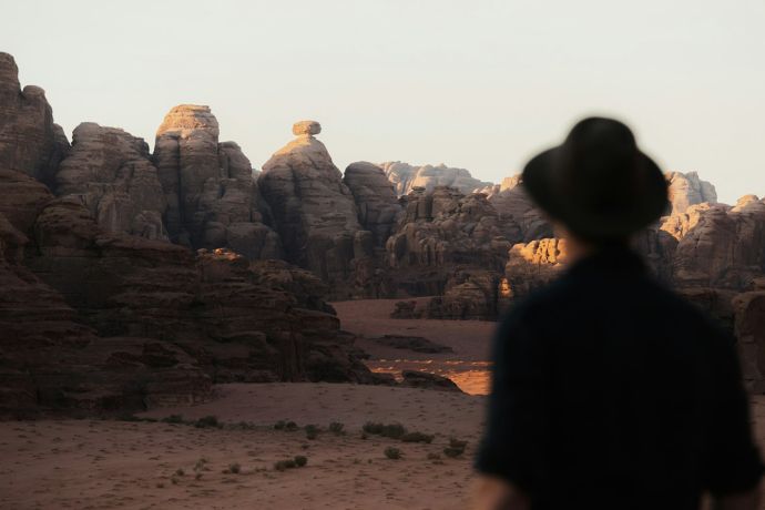 A person standing in front of a mountain range