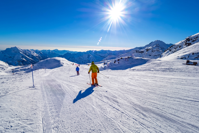 Person skiing down a snowy slope in the Alps. Person skiing down a snowy slope in the Alps.