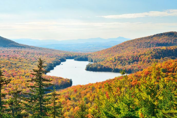 Lake with autumn foliage viewed from mountain top in new england stowe
