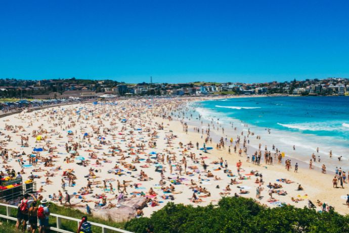 Sunbathers and swimmers on Bondi Beach on a sunny day in Sydney, Australia